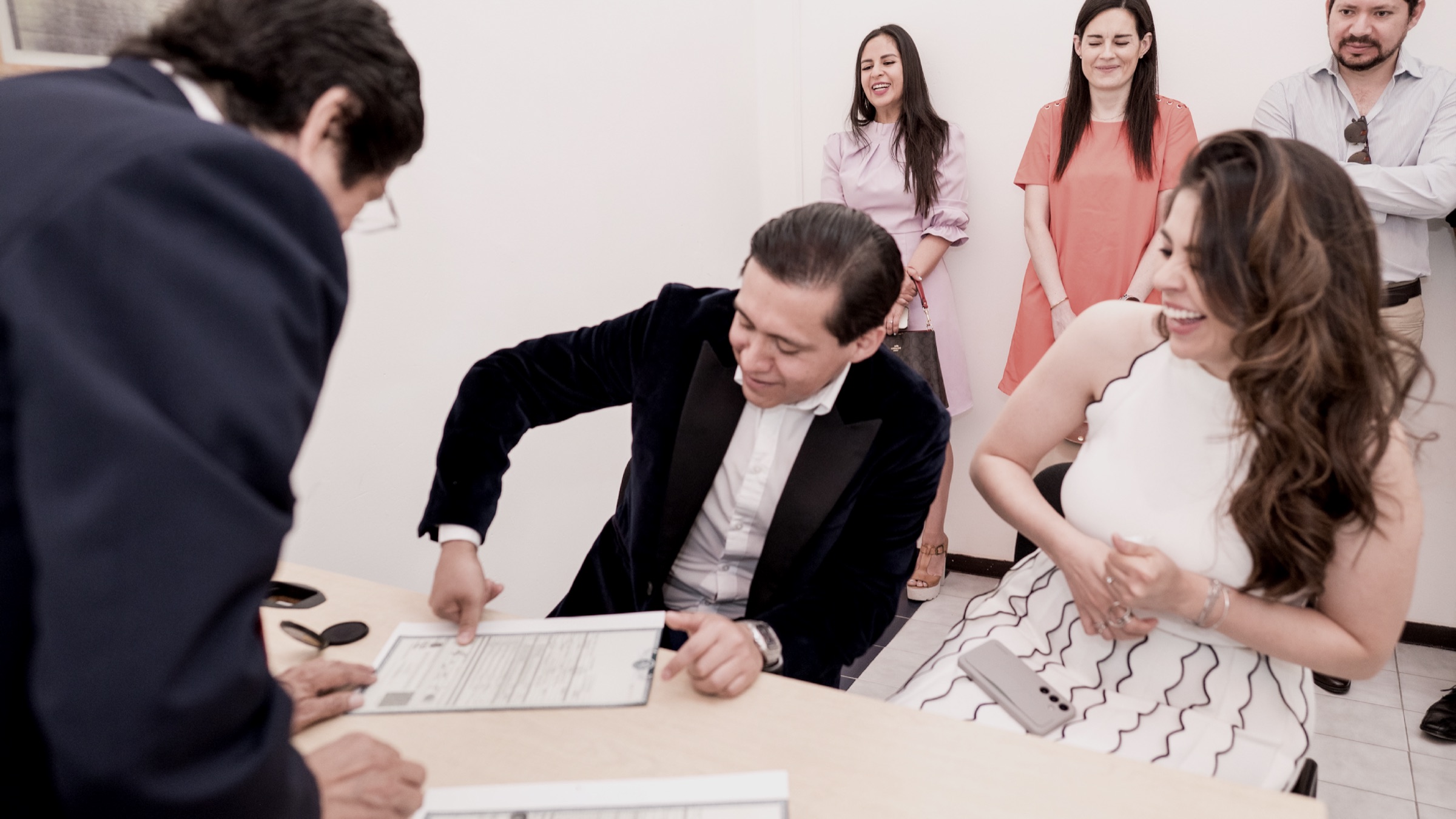 Omar and Maggie signing at their wedding